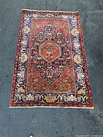 Full top-down view of rectangular rug on asphalt