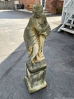 Front view of statue and pedestal on driveway