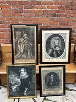 Overall view of four framed black and white engraved portrait prints arranged against brick background.