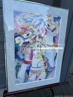 Frontal photo of the lithograph showing colorful horses in a silver frame and matting.