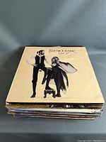 Stack of vintage vinyl albums topped with Fleetwood Mac 'Rumours' album.
