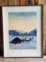 Framed watercolour painting of a snowy mountain village landscape by Edwin Hermann.