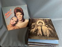 Photo shows front covers of David Bowie's 'Aladdin Sane' and Pete Townshend's 'Empty Glass' albums stacked.