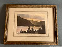 Framed print showing the entire artwork, frame, and mat board. Title and signature visible.