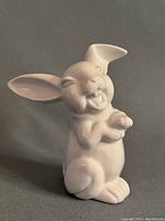 Front angle view of the white porcelain bunny figurine with detailed facial features and upright ears.