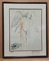Framed vintage print showing angel figure with wings and a chariot scene in background.