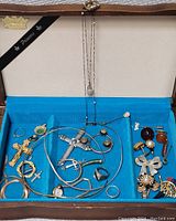 Main tray view showing various jewelry items on blue fabric background