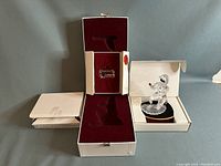 Photo showing the entire lot including the open display box with red velvet interior, a crystal plaque, and the Harlequin crystal figurine in the box.