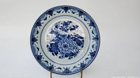 Front view of the Delft blue and white floral decorative plate showing the full floral design and patterned border in cobalt blue on white.