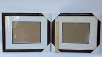 Photo showing both picture frames side by side with a measuring stick to show dimensions approximately 23 inches by 19 inches.