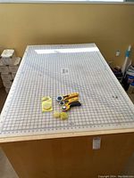 Full view of cutting mat on table with three rotary cutters and refill items centered