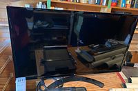 Front view of LG 32 inch monitor on black stand with screen off.