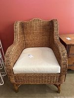 Front view of wicker armchair with cushion