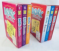 Two boxed sets of Dork Diaries books with three books each, showing book numbers 1-3 and 4-6 in color-coded spines.