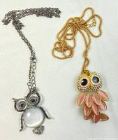 Both owl pendant necklaces together on white background showing size and overall condition.