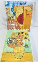 Two hardcover Van Gogh art books standing upright, front covers visible. One shows a room with yellow furniture, the other shows sunflowers in a vase.