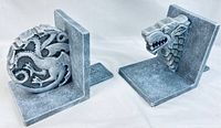 Both stone bookends showing detailed dragon designs and L-shape.