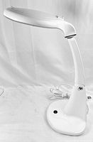 Side view of the OHM lighted magnifying lamp showing the lamp head, arm, base, and power cord