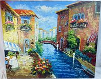 Full view of the colorful oil painting of an Italy canal scene showing buildings, water, bridge, and flower pots along the walkway.