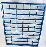 Front view showing blue frame with 60 clear plastic drawers in rows and columns.