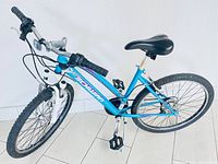 Full view of the blue Schwinn mountain bike, showing frame, wheels, seat, and handlebars.