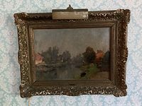 Front view of oil on canvas landscape painting in carved wood frame