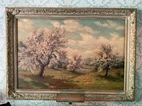 Full front view of the framed painting against patterned wall.