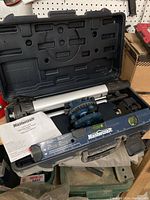 Mastercraft laser level in carrying case with tripod and instruction manual.