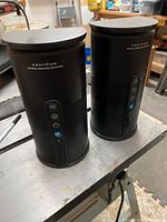 Front and top view of both Centrios wireless speakers showing buttons and overall condition.