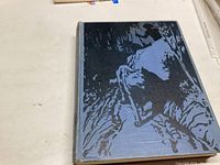 Front cover of the 1952 'All The Mowgli Stories' book showing a wolf illustration in a forest scene.