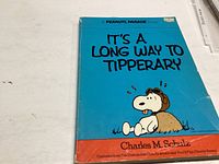 Front cover of a softcover Peanuts book with Snoopy in aviator gear and the title 'It's A Long Way To Tipperary'