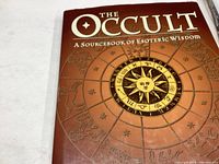 Front cover of the book showing the title and zodiac-themed design with a sun in the center.