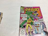 Color photograph of Star Wars Droids comic book issue #1 featuring C-3PO, R2-D2 and other droids on the cover, with comic book details visible.