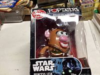 Front-side view of the boxed Princess Leia Mrs. Potato Head collectible, showing clear plastic display window and Star Wars branding.