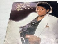 Front cover of Michael Jackson Thriller vinyl album showing Michael Jackson in a white jacket.