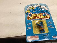 Front view of unopened Smurfette hula dancing figure in original Irwin packaging showing the figure through blister pack and colorful card.