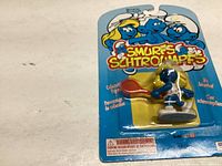 Photo of unopened Smurfette playing tennis figurine in original packaging showing front card and blister