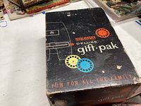 Top and side views of the View-Master Deluxe Gift Pak box with colorful graphics and text highlighting family fun.