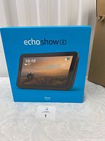 Front view of unopened Amazon Echo Show 8 box with product image and branding.
