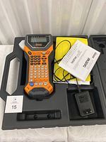 Top view of Brother P Touch Edge label maker in carrying case along with charger and manuals.