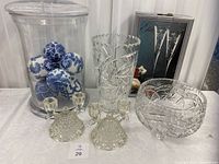 Full lot assortment showing all crystal and porcelain items on display, including candy jar with porcelain balls, candle holders, crystal vase and bowl, boxed champagne flutes.