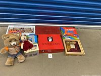 Full lot showing Teddy Ruxpin doll, puzzles in packaging, and various boxed board games including Scattergories and Scrabble