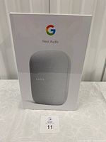 Front view of sealed Google Nest Audio box showing speaker image and branding.