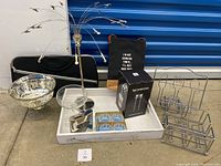 Overview of assorted items including candy dish, glass tray, flask, wine bag, metal holders, and boxed Nespresso Aeroccino 3