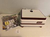 Grinder on table next to sealed hand tool kit in blister pack