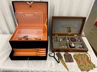 Overview of all items in the lot including two jewelry boxes, various jewelry pieces, vintage metal purses, and small accessories.