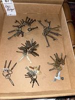 Overview photo showing all six sets of antique keys in a cardboard box.