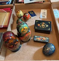 Overview of the lot showing the two Matryoshka dolls, the three colorful paper mache eggs, two trinket boxes and the blue Kashmiri egg.