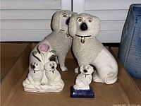 All four figurines in cardboard box