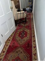 Hallway view of runner rug laid between rooms